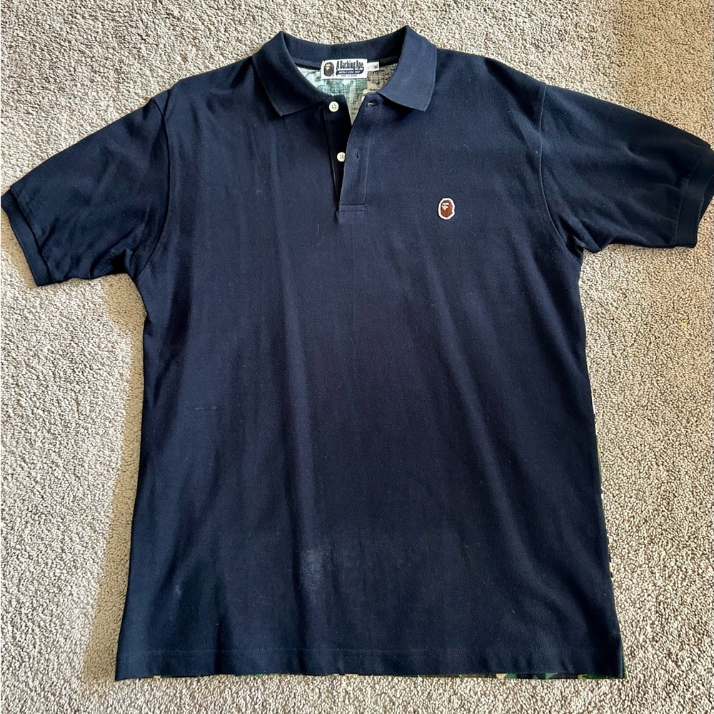 Bape- A Bathing Ape short sleeve polo. Black front with custom ‘camo print’ back